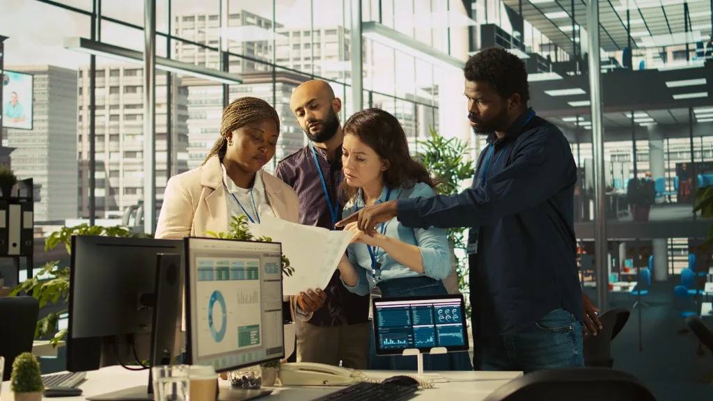 Enterprise team collaborating on data dashboards and business transformation